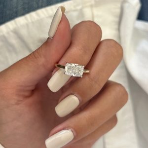 Radiant cut solitaire engagement ring in mixed metal four-prong basket setting