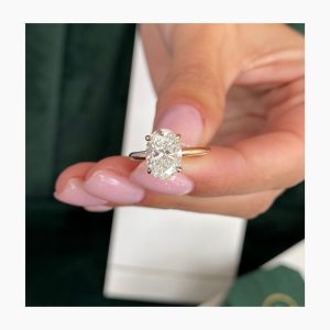 Oval solitaire engagement ring with four-prong minimal basket and plain band