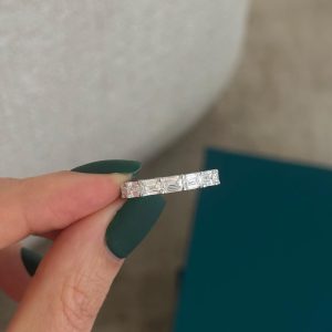 Alternating baguette and round diamond eternity band with shared prong setting