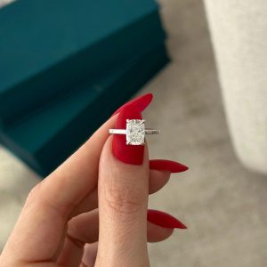 Rectangular cushion solitaire engagement ring with pavé diamond gallery on plain band