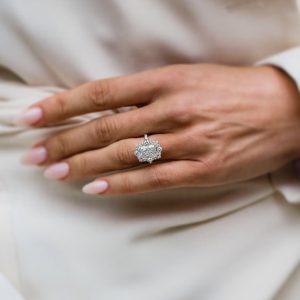 Rectangular radiant cut halo diamond engagement ring with pavé band