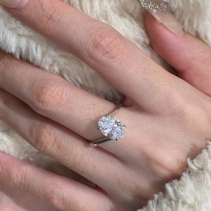 Oval solitaire engagement ring with a 4-prong setting and plain polished band