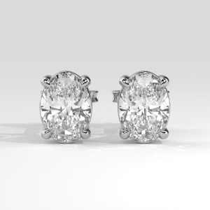 Pair of oval diamond stud earrings in four-prong basket settings